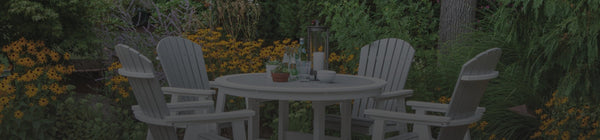 Outdoor entertaining ideas include a nice setup like this round table and Adirondack-style chairs.